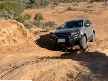 Climbing steep scalloped terrain in a new Isuzu MUX.